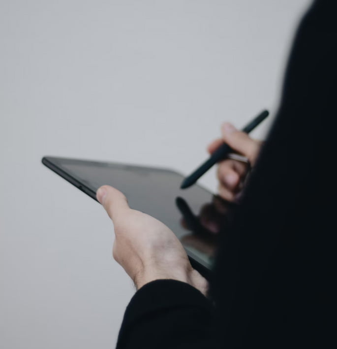 woman working on a tablet with a tablet pen