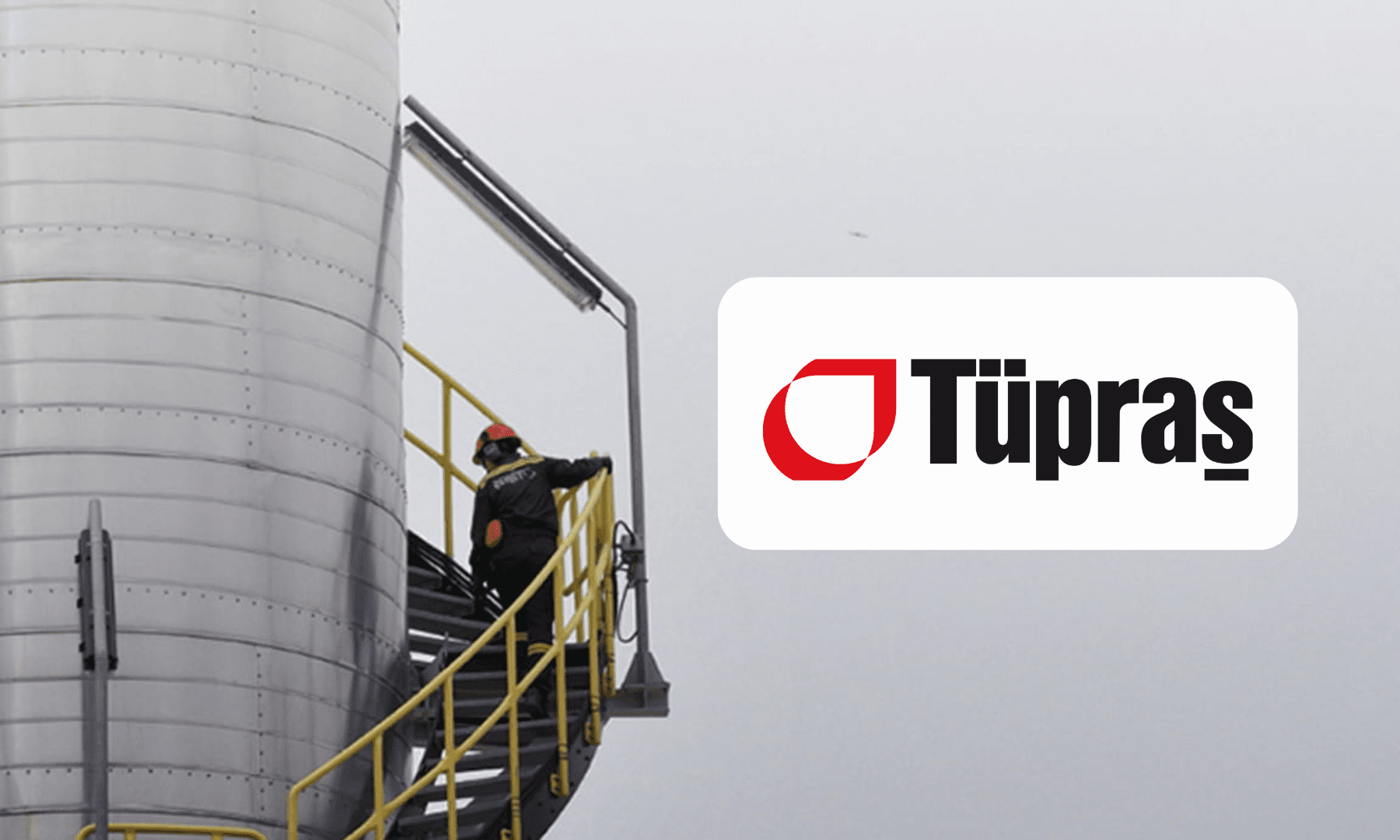 a refinery worker climbing on a high ladder on a very cloudy day, tupras logo
