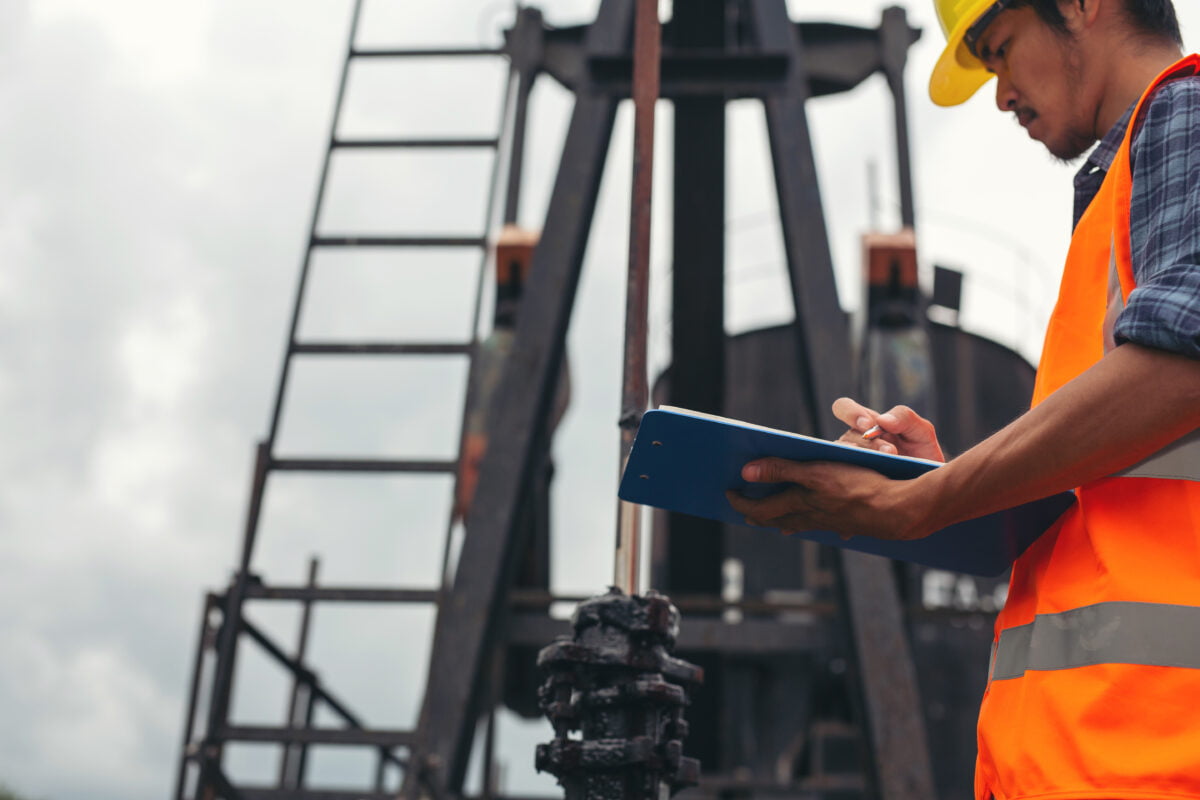 worker in oil and gas doing with an equipment inspection checklist
