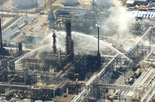 firefighters battle a blaze and search for victims of an explosion at the bp plant that killed at least 15 people wednesday, march 23, 2005, in texas city, texas. (photo by brett coomer/chronicle) houchron caption (09/17/2005) secnews: grim scene: fire crews battle a blaze and search for victims of the march 23 explosion that killed 15 people at the bp refinery in texas city. federal fines are expected soon in connection with the deadly blast.